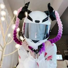 a person wearing a helmet with horns on their head and lights around the neck,