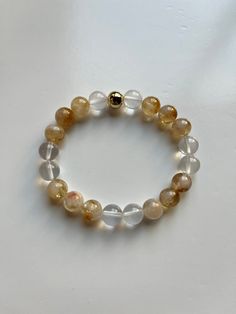 This bracelet is made with Milky Quartz and Sponge Citrine both very unique looking crystals, that together will provide you with calming and happy thoughts and help cheer you up and see the good in everything.  Milky quartz is characterized by its milky appearance. It has a gentler energy than clear quartz and is often used for its calming and soothing properties. It helps relieve feelings of overwhelm, release limitations, and open you to new possibilities. It also promotes cooperation and helps you think before speaking (Consider) and connects you to your inner wisdom. 1.Soothing 2.Release Limitations 3.Cooperation 4.Consider 5.Inner-wisdom Sponge Citrine has natural inclusions cause the cloudy aspect; these are not considered flaws but rather unique characteristics that add to the ston Citrine Bracelet, Cheer You Up, Les Sentiments, Happy Thoughts, Clear Quartz, Arm Band, Citrine, Jewelry Bracelets, Bracelet