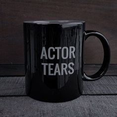 a black coffee mug with the words actor tears on it