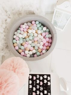 a bowl filled with candy sitting on top of a table