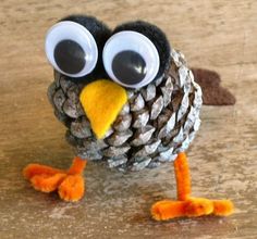 an owl made out of pine cones with googly eyes