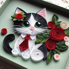 a cat made out of paper with flowers on it