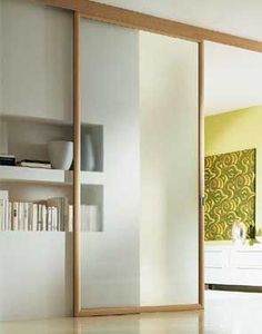 an open sliding door in a living room with white walls and yellow accents on the wall