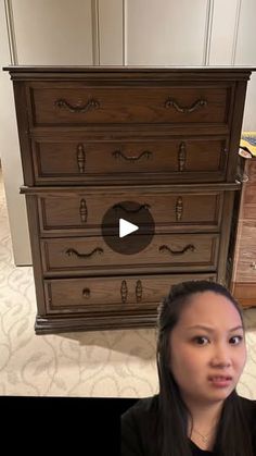 a woman sitting in front of a dresser