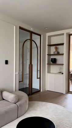 a living room filled with furniture and white walls