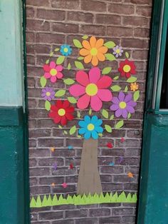 a door decorated with paper flowers and a tree