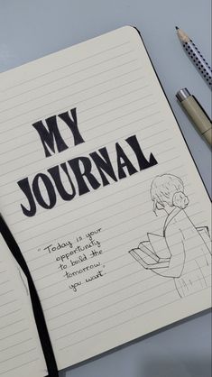 an open notebook with the words my journal written on it next to a pair of pencils