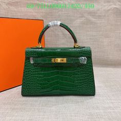 a green handbag sitting on top of a table next to an orange book case