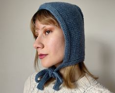 "Bow tie bonnet in denim blue One of the headgear trends of 2023 is hand-knit bonnets. They have been lovely head-wear pieces of 19th century and nowadays they take place on the modern fashion world. These knitted bow-tie hoods are cozy head accessories for cottage-core style lovers. 🌿 This adult bonnet is hand knitted with pure merino wool, a luxurious and soft material that will keep you warm and comfortable in cold weather. The breathable wool material makes it perfect for outdoor activities Knitted Bow, Knit Bonnet, Cottage Core Style, Warm Winter Hats, Head Wear, Tie Length, Winter Cap, Cap Fashion, Knitted Hood