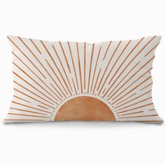 an orange and white pillow with the sun shining down on it's back side