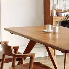 a wooden table with two cups on it