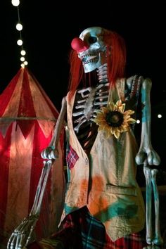 a skeleton dressed up in tartan and plaid with a sunflower on his chest