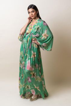 Green chiffon kaftan dress with floral print and sequins hand embroidered placket and neckline. Comes with an inner.
Components: 2
Pattern: Printed, Hand embroidered
Type Of Work: Floral, Sequins
Neckline: V Neck
Sleeve Type: Flared Sleeves
Fabric: Chiffon
Color: Green
Other Details: 
Length : Dress - 57 inches
Occasion: Party - Aza Fashions Floral Print V-neck Kaftan For Party, Party Floor-length Kaftan With Floral Embroidery, Vacation Georgette Maxi Dress, Elegant Green Georgette Kaftan, Green Floral Print Maxi Kaftan, Green Embellished Chiffon Dress, Bollywood Style V-neck Dress With Floral Embroidery, Sequin Maxi Beach Dress, Party Georgette Kaftan In Maxi Length