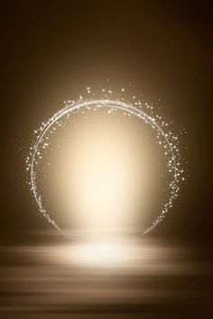 a circular light with sparkles in the middle on a dark background, reflecting off water