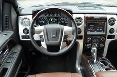 the interior of a vehicle with dashboard, steering wheel and dash board showing various gauges