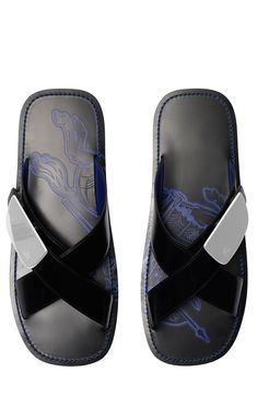 The archival Equestrian Knight Design ennobles this leather slide with a logo-etched shield buckle and logo-embossed footbed. A Burberry-debossed strip centers the tread. Adjustable strap with buckle closure Leather upper and lining/synthetic sole Made in Italy Designer Shoes Burberry Slides, Knight Design, Engraved Plaque, Men's Sandals, Shield Sunglasses, Leather Slides, Slides Shoes, Burberry Men, Mens Sandals