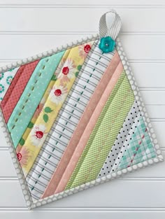 a close up of a piece of fabric on top of a white table with flowers and polka dots