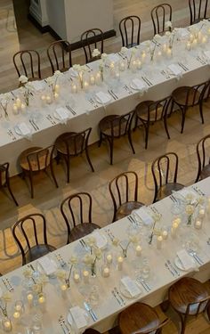 long tables with white tablecloths and candles on them