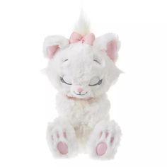 a white stuffed animal with pink ears and eyes