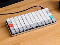 a computer keyboard sitting on top of a wooden desk