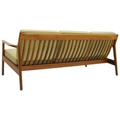 a wooden bench with striped cushions on it's back legs and armrests