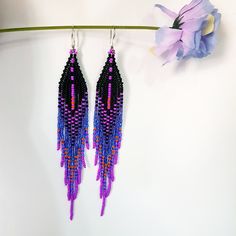 New color combination Seed Bead Earrings 5 inch long.Flowing beads earrings.The predominant colors are Black,Dark Purple,Sparkling blue,Fuchsia,Orange color . Sterling silver ear wire.Different shades of colors seamlessly blend into each other.These are luxurious earrings for every day and also for an evening out. Materials; Japanese seed beads. Czech seed beads. sterling silver 925 plated ear wire. Weight Earrings( 6g) Purple Beaded Fringe Earrings For Festivals, Purple Festival Jewelry With Black Beads, Purple Jewelry With Black Beads For Festival, Purple Beaded Dangle Earrings With Black Beads, Purple Dangle Beaded Earrings With Black Beads, Purple Dangle Earrings With Black Beads, Purple Beaded Dangle Earrings For Festival, Purple Dangle Beaded Earrings For Festival, Purple Beaded Fringe Jewelry For Festival