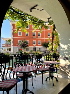 an outdoor patio with tables and chairs