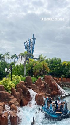 people are riding on a boat in the water at seaworld's theme park