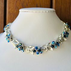 Lisner Necklace Brilliant Blues Multiple Shades of Blue AB Rhinestones with Dimensional Silver-tone Grape Leaves. In Excellent Condition  16" adjustable length Blue Jeweled Necklace For Party, Party Blue Necklaces With Sparkling Stones, Blue Necklaces With Sparkling Stones For Party, Blue Party Necklace With Sparkling Stones, Sapphire Rhinestone Party Necklace, Blue Rhinestone Necklaces For Evening, Blue Rhinestone Necklace For Evening, Blue Adjustable Jewelry With Sparkling Stones, Adjustable Blue Jewelry With Sparkling Stones