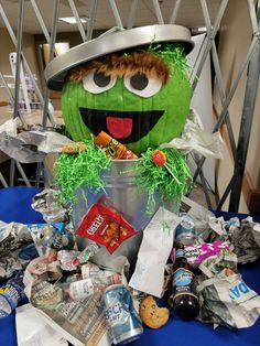 a large green pumpkin sitting on top of a table filled with candy and candies