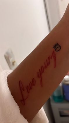 a woman's wrist with the words i love you written on her left arm