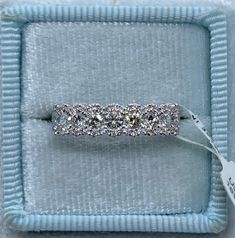 a diamond ring in a blue box with a price tag on the inside of it