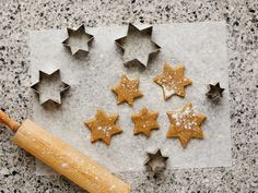 star shaped cookies on a cookie sheet with a rolling pin