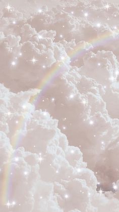 there is a rainbow in the sky with clouds and stars all around it on this day