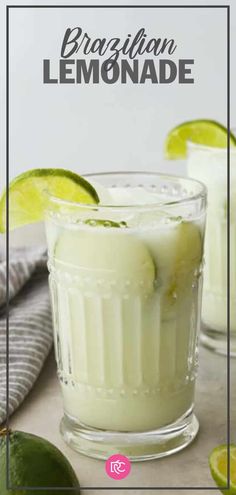 two glasses filled with lemonade on top of a wooden table next to limes