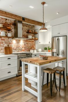 a kitchen with white cabinets and an island in front of a stove top oven next to two stools