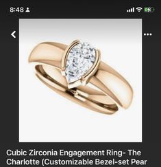 a gold ring with a heart shaped diamond on it's side and the words, cubic