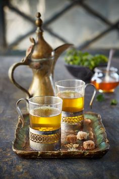 two glasses of tea sit on a tray