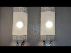 two white lights are on the wall next to each other