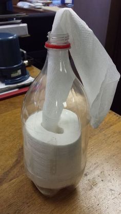 a roll of toilet paper in a glass bottle