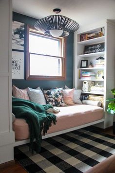 a living room filled with lots of furniture and bookshelves next to a window