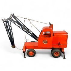 an orange toy truck with a crane attached to it