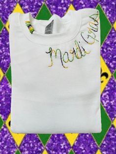 Hand embroidered multicolored thread embroidered Mardi Gras crewneck Diy Mardi Gras Shirt, Mardi Gras Embroidery, Spring Crew Neck Sweater With Embroidered Logo, Long Sleeve T-shirt With Multicolor Embroidery, Multicolor Embroidered Logo Sweatshirt Crew Neck, Embroidered Logo Crew Neck Sweatshirt, Multicolor Embroidered Text Crew Neck Sweatshirt, Multicolor Long Sleeve Tops With Embroidered Graphics, Mardi Gras Embroidery Designs