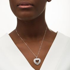 Surprise the one you love with this gorgeous diamond heart pendant. Fashioned in sterling silver, this marvelous style showcases a heart-shaped outline shimmering with tapered baguette-cut diamonds between polished borders. A shadow frame of round diamonds surrounds the center in sparkle. Captivating with 1 ct. t.w. of diamonds and a bright polished shine, this pendant suspends along an 18.0-inch box chain that secures with a spring-ring clasp. Silver Heart-shaped Diamond Necklace With Pave Setting, Heart Cut Diamond Jewelry With Polished Finish, Luxury Diamond Open Heart Necklace, Luxury Open Heart Diamond Necklace, Luxury Silver Diamond Heart Pendant Necklace, Luxury Silver Heart Pendant Diamond Necklace, Silver Heart Pendant Luxury Diamond Necklace, Heart-shaped Diamond Jewelry With Polished Finish, Heart Shaped Diamond Jewelry With Polished Finish