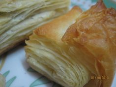 two pieces of pastry sitting on top of a plate