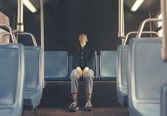 a person sitting on a bus with their eyes closed