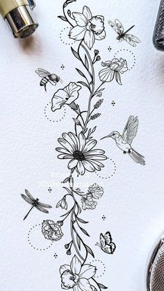 an ink drawing of flowers and birds on white paper with black marker pens next to it