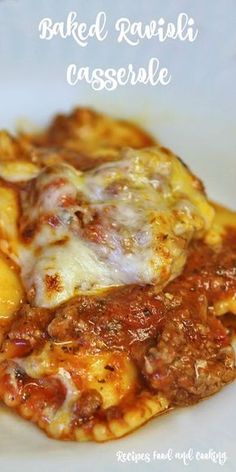 baked ravioli casserole on a white plate with cheese and meat in sauce