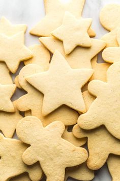 some cut out cookies are sitting on a counter top with one cookie in the shape of a star