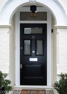 a black front door on a white brick building